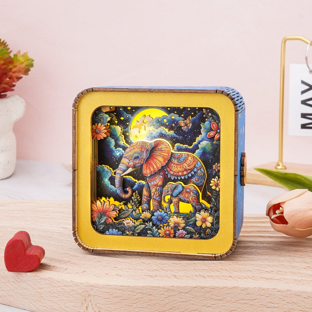 3D wooden puzzle night light featuring an elephant under the moon with vibrant colors and floral accents.