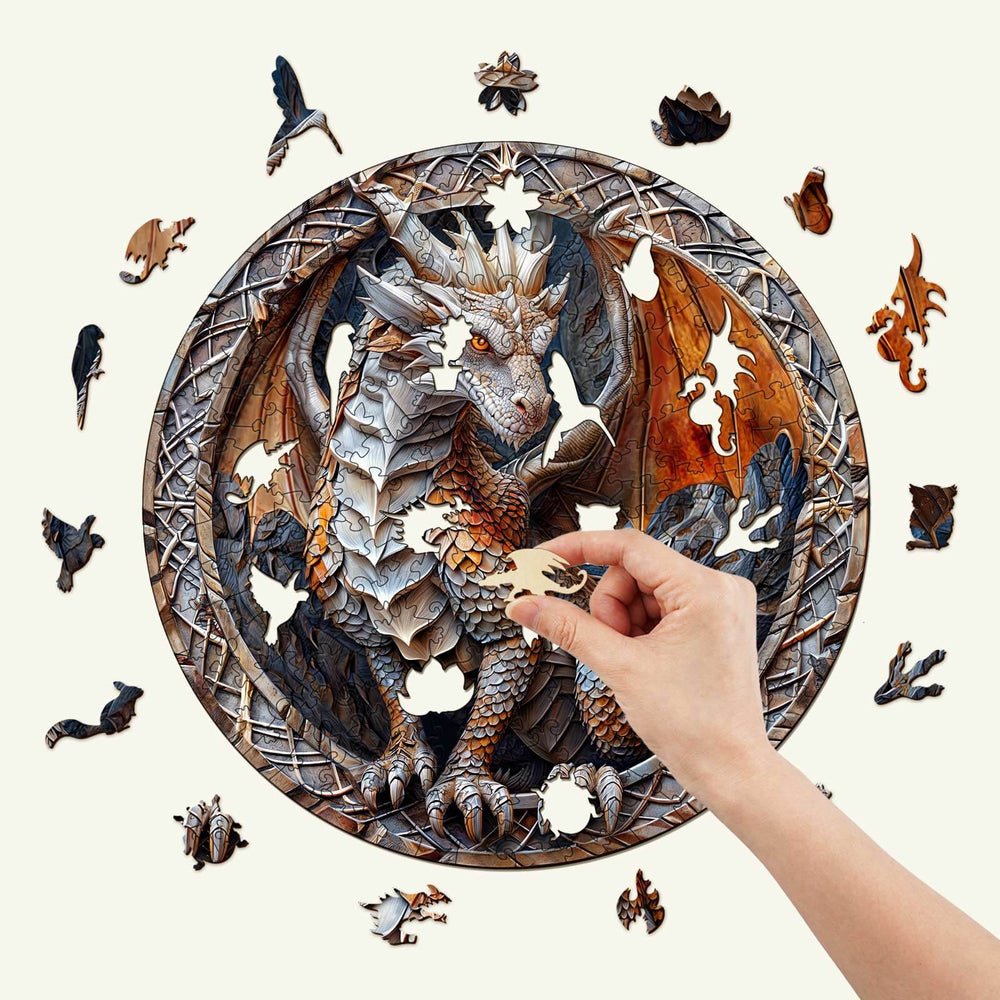 Person inserting a piece into a 3D Cave Dragon wooden jigsaw puzzle, featuring intricate dragon designs.