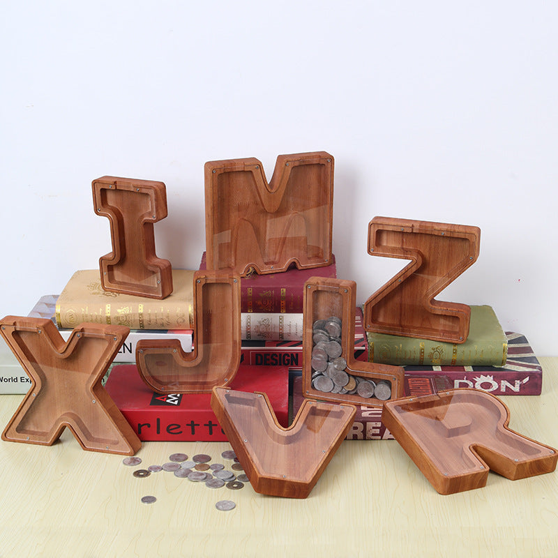Personalized wooden letter piggy banks for kids, promoting savings and financial awareness, displayed with coins and books.