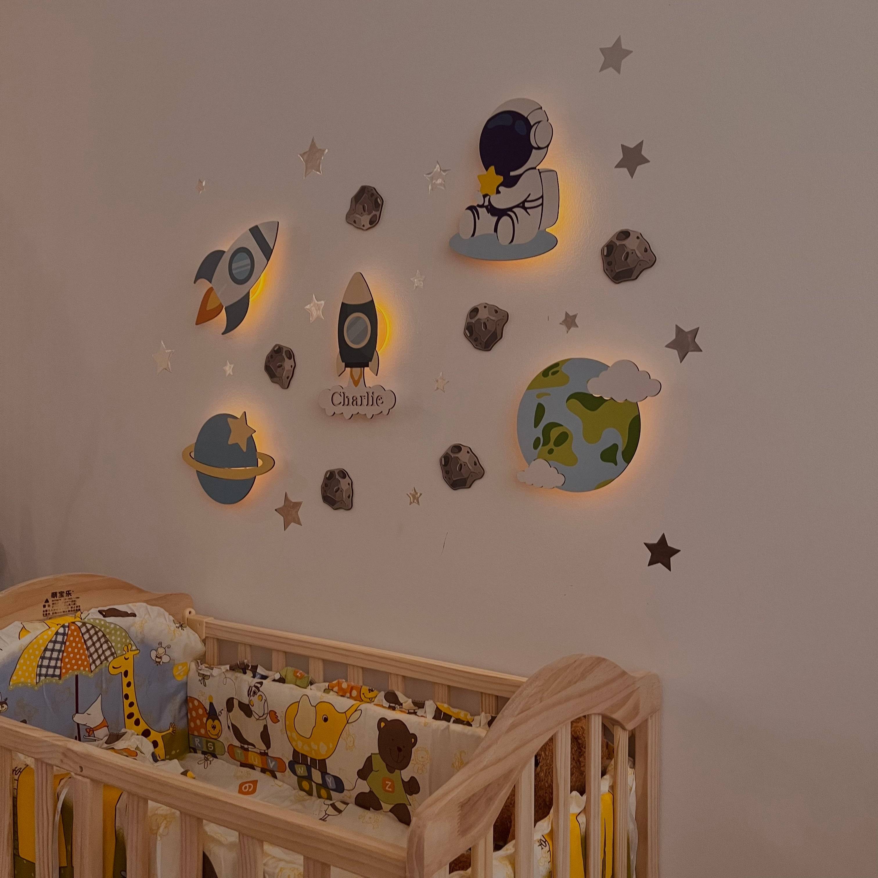 Personalized wooden wall light set for baby room, featuring space models, soft glow for comfort and easy installation.