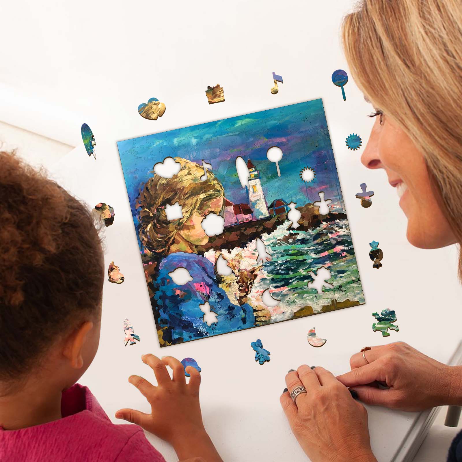 A mother and child engaging with an artistic puzzle featuring a colorful lighthouse scene by Arlet Gomez.