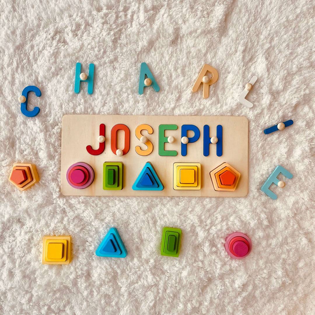 Personalized wooden stacking toy featuring the name JOSEPH, colorful letters, and geometric shapes for educational fun.