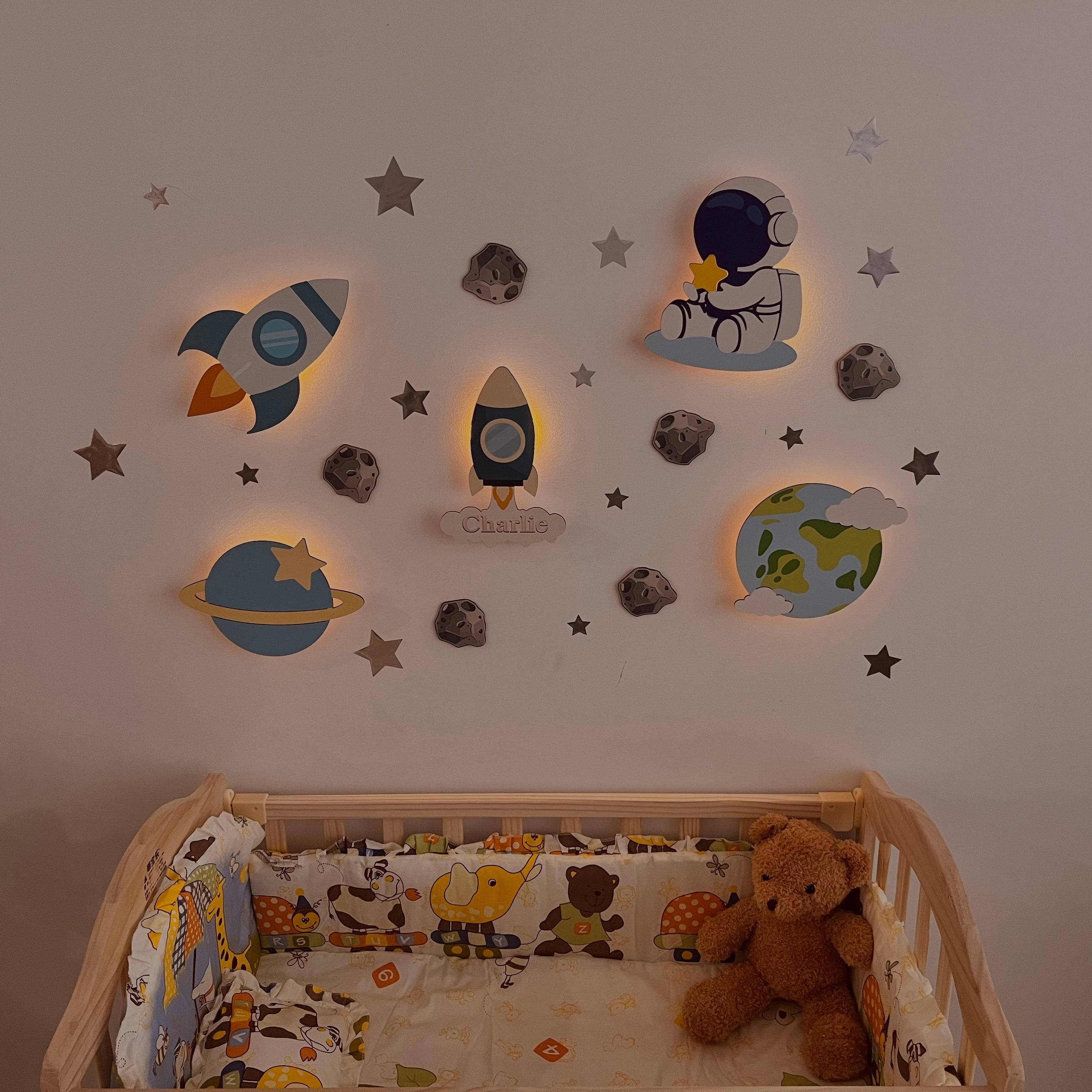 Personalized wooden wall light set for baby's room featuring space model designs, providing soft, comforting glow.