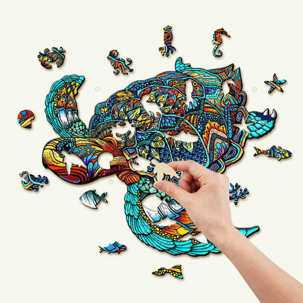 Hand assembling a vibrant Resolute Turtle Wooden Jigsaw Puzzle with unique animal-shaped pieces.