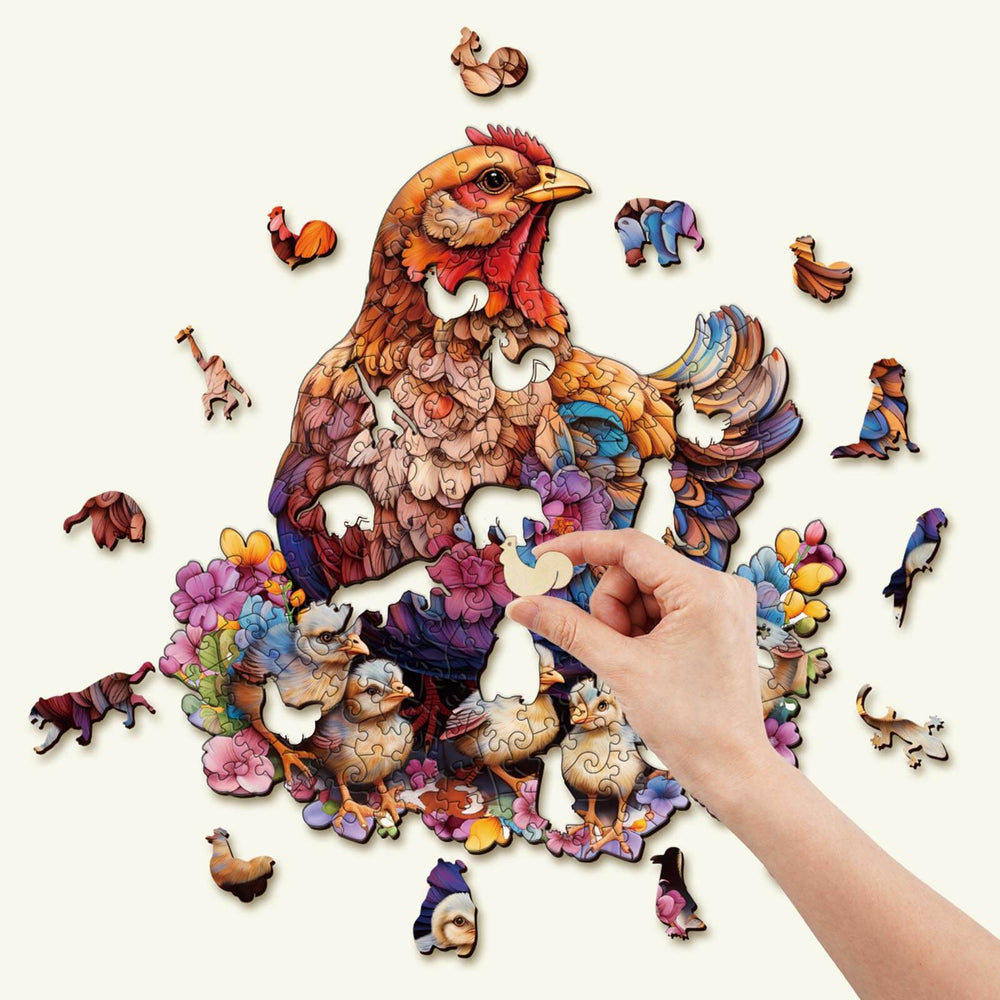 Colorful wooden jigsaw puzzle featuring a hen and farm animals, with a hand adding a piece.